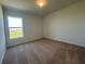 Carpeted bedroom featuring a window with a view of the outdoors at 1212 Caloosa Ridge Ave, Babson Park, FL 33827