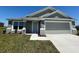 Inviting single-story home with a neutral color palette, stone accents, and a convenient attached garage at 1212 Caloosa Ridge Ave, Babson Park, FL 33827