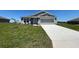 Charming single-Gathering home with a well-manicured lawn and a spacious two-car garage and stone trim at 1212 Caloosa Ridge Ave, Babson Park, FL 33827
