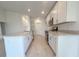 Stylish kitchen with white cabinets, stainless steel appliances, and tile flooring at 1212 Caloosa Ridge Ave, Babson Park, FL 33827