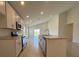 Bright kitchen featuring stainless appliances, stone tile floor, and a large island counter with breakfast bar at 1212 Caloosa Ridge Ave, Babson Park, FL 33827