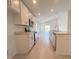 Modern kitchen featuring stainless steel appliances, white cabinets, and a convenient kitchen island at 1212 Caloosa Ridge Ave, Babson Park, FL 33827