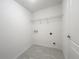 Laundry room with tile flooring, wire shelving, and utility connections at 1212 Caloosa Ridge Ave, Babson Park, FL 33827