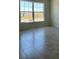 Neutral living room featuring tile floor and abundant light through a double window at 1212 Caloosa Ridge Ave, Babson Park, FL 33827
