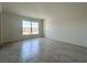 Spacious living room with neutral walls, modern tile floors, and a bright, sunny window at 1212 Caloosa Ridge Ave, Babson Park, FL 33827