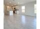 Open-concept living space with tile flooring, kitchen, and bright natural light at 1212 Caloosa Ridge Ave, Babson Park, FL 33827