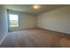 Comfortable bedroom featuring neutral walls, soft carpeting, and a large window for natural light at 1212 Caloosa Ridge Ave, Babson Park, FL 33827