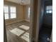 This cozy bedroom has a ceiling fan, wood-look floors, and multiple windows at 134 Daytona Ave, Daytona Beach, FL 32117
