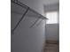 A walk-in closet has white walls, wood floors, a metal shelf, and a window at 134 Daytona Ave, Daytona Beach, FL 32117