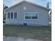 Quaint, stucco home with white trim, green lawn, and flower bed accents at 134 Daytona Ave, Daytona Beach, FL 32117