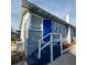 Corner view of the blue front door and white railing at 134 Daytona Ave, Daytona Beach, FL 32117