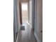 A bright hallway features a wood floor, white trim, and doorways to other rooms at 134 Daytona Ave, Daytona Beach, FL 32117