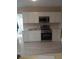 Well-lit kitchen features stainless steel appliances, white cabinets, and wood-look flooring at 134 Daytona Ave, Daytona Beach, FL 32117