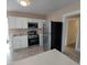 Modern kitchen features stainless steel appliances, white cabinetry, and durable flooring at 134 Daytona Ave, Daytona Beach, FL 32117