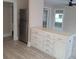 Bright kitchen featuring a stainless steel refrigerator and white cabinetry with modern hardware and countertop at 134 Daytona Ave, Daytona Beach, FL 32117