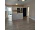 Open-concept kitchen and dining area with new flooring at 134 Daytona Ave, Daytona Beach, FL 32117