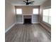 Bright living room with a brick fireplace and light wood floors at 134 Daytona Ave, Daytona Beach, FL 32117