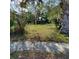 Vacant lot with grass and mature shade trees at 134 Daytona Ave, Daytona Beach, FL 32117