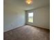 Cozy bedroom featuring carpeted floors, a window for natural light, and closet at 141 W 6Th St, Frostproof, FL 33843