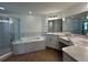 Elegant bathroom featuring a soaking tub, separate shower, dual sinks, and sleek fixtures at 141 W 6Th St, Frostproof, FL 33843
