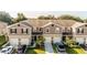 Aerial view of well-maintained townhomes with neat landscaping, driveways, and attached garages at 1412 Mirabella Cir, Davenport, FL 33897