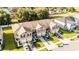 Aerial view of the community, featuring townhomes, landscaping, and nearby trees at 1412 Mirabella Cir, Davenport, FL 33897