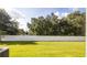 Spacious backyard features green grass, privacy fence, and mature trees for outdoor enjoyment at 1412 Mirabella Cir, Davenport, FL 33897