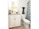 Bathroom with a toilet, shower curtain, and granite countertop at 1412 Mirabella Cir, Davenport, FL 33897