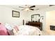 Cozy bedroom featuring soft pillows, patterned bedding, and ceiling fan for a relaxing atmosphere at 1412 Mirabella Cir, Davenport, FL 33897
