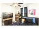 Bedroom with dark bedding, a window with curtains, and a chest of drawers at 1412 Mirabella Cir, Davenport, FL 33897