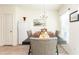 Comfortable dining room with table set for a meal, a refrigerator, and picture window at 1412 Mirabella Cir, Davenport, FL 33897