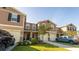 Attractive townhome featuring an attached garage, beautiful landscaping, and a private driveway at 1412 Mirabella Cir, Davenport, FL 33897