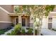 Charming townhome featuring a welcoming front door with a decorative wreath and lovely landscaping at 1412 Mirabella Cir, Davenport, FL 33897