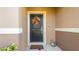 Front door decorated with a fall wreath on a beige house at 1412 Mirabella Cir, Davenport, FL 33897