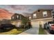 Charming townhome featuring a neutral color palette, attached garage, and well-kept landscaping at 1412 Mirabella Cir, Davenport, FL 33897