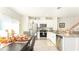 Open floor plan featuring a modern kitchen with stainless steel appliances and dining table at 1412 Mirabella Cir, Davenport, FL 33897