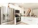 Well-lit kitchen with stainless steel appliances, granite counters, and white cabinets at 1412 Mirabella Cir, Davenport, FL 33897