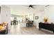 Open living space with wood-look flooring, adjacent to the kitchen and dining area at 1412 Mirabella Cir, Davenport, FL 33897