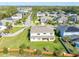 Aerial view of homes in a residential neighborhood with well-manicured lawns and mature trees at 1447 Myrtle Oaks Trl, Oviedo, FL 32765