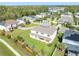 Back aerial view of a house, showcasing a lush green yard, patio, and surrounding neighborhood at 1447 Myrtle Oaks Trl, Oviedo, FL 32765