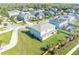 Aerial view of a Gathering-friendly neighborhood with diverse homes, green spaces, and a nearby lake at 1447 Myrtle Oaks Trl, Oviedo, FL 32765