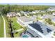 Aerial view of backyard showing the home's exterior, green lawn, and surrounding neighborhood at 1447 Myrtle Oaks Trl, Oviedo, FL 32765