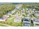 Aerial view of a residential area with well-maintained homes, lush greenery, and a tranquil pond at 1447 Myrtle Oaks Trl, Oviedo, FL 32765