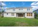 Backyard with a sliding glass door leading to the patio at 1447 Myrtle Oaks Trl, Oviedo, FL 32765