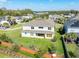 Exterior view of backyard, featuring large grass area, patio, and exterior of home at 1447 Myrtle Oaks Trl, Oviedo, FL 32765