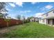 Spacious backyard with a brick fence and grassy lawn at 1447 Myrtle Oaks Trl, Oviedo, FL 32765