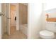 Bathroom featuring a modern toilet, white tub and shower, and a decorative wooden duck at 1447 Myrtle Oaks Trl, Oviedo, FL 32765