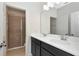Modern bathroom featuring double sinks, a dark vanity, and walk-in glass enclosed shower at 1447 Myrtle Oaks Trl, Oviedo, FL 32765