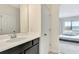 Bathroom featuring a single sink with a black vanity and access to a bedroom at 1447 Myrtle Oaks Trl, Oviedo, FL 32765