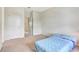 Neutral bedroom with carpet and a blue patterned bed, featuring two closets for ample storage space at 1447 Myrtle Oaks Trl, Oviedo, FL 32765